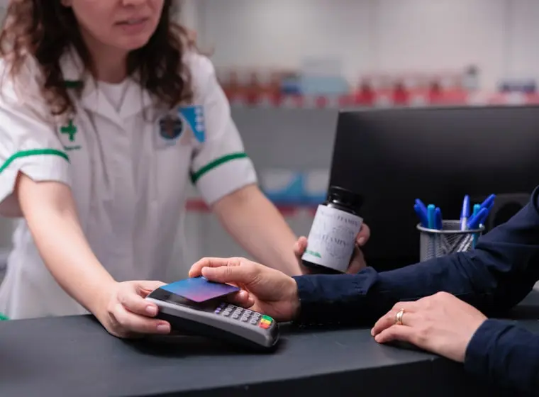A nurse holding the patient payment solution credit card reader
