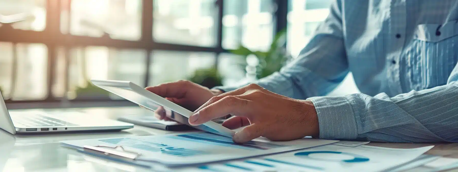 a sleek, modern office workspace features a focused professional engaging with a digital tablet, surrounded by organized documents and a laptop, highlighting the efficiency of rapid claim submissions against a backdrop of large windows with a city skyline view.